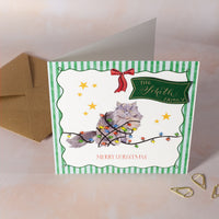 Christmas card with a cat tangled in lights, personalised name on green card with gold calligraphy