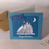 Personalised Christmas card with penguin under starry sky and 'Merry Christmas' text on a blue background