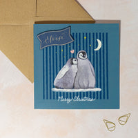 Personalised Christmas card with penguins and 'Merry Christmas' text on a navy blue background