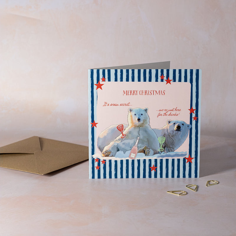 Christmas card with polar bears and bottle of fizz. 'It's snow secret, we're just here for the drinks!'