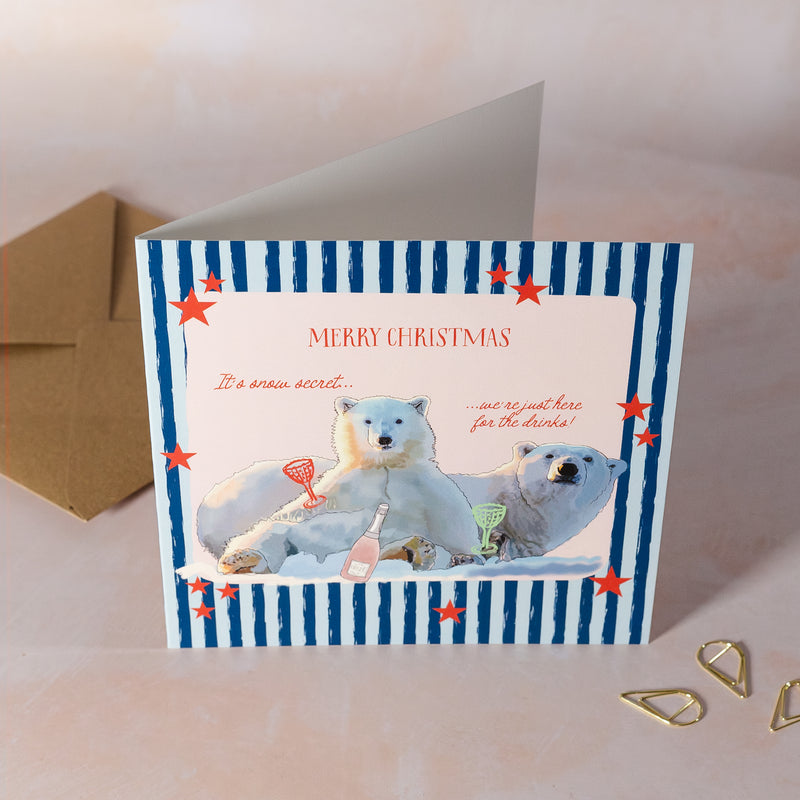 Christmas card with polar bears enjoying a festive drink.