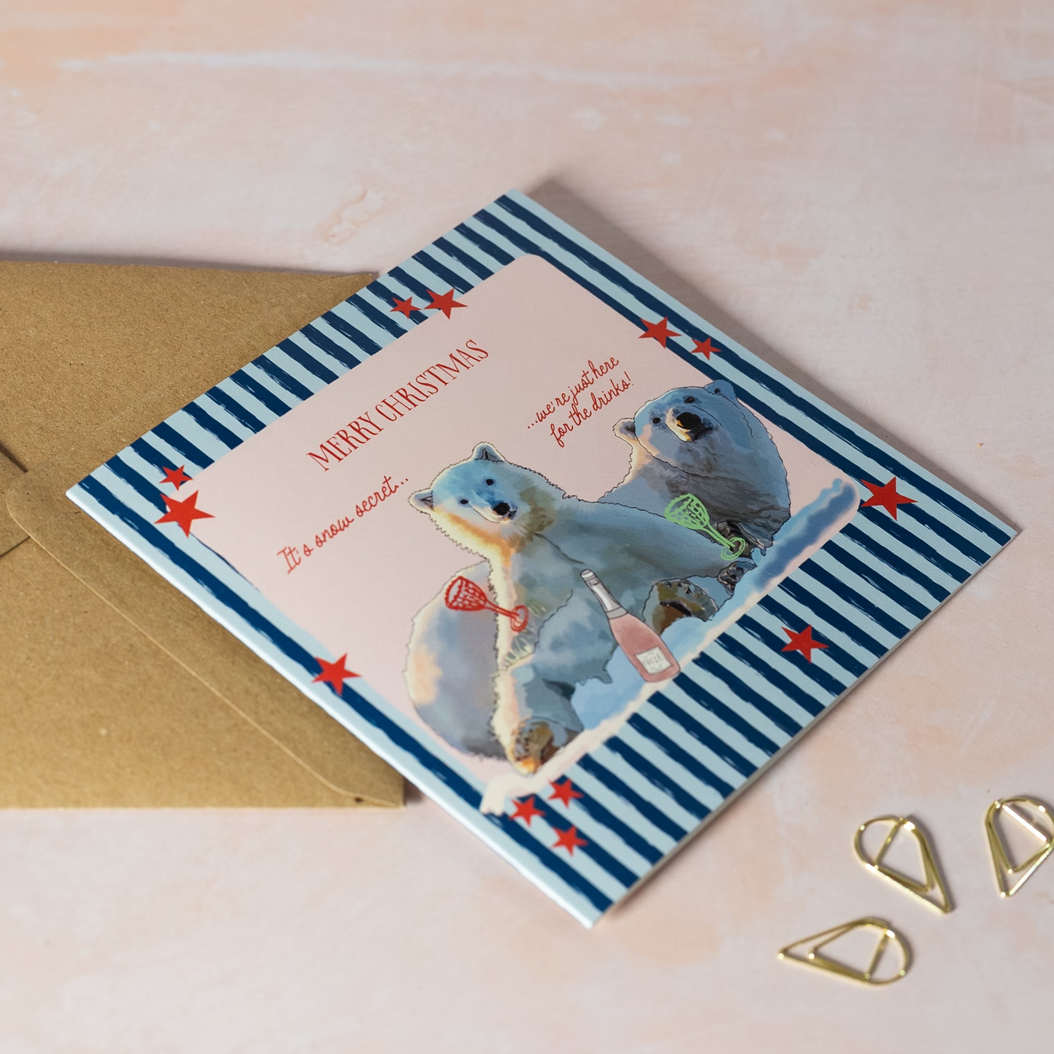 Fun Christmas card with two polar bears and a striped blue background with red stars.