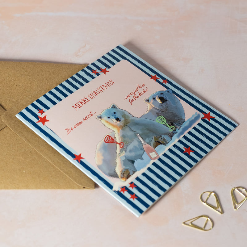 Fun Christmas card with two polar bears and a striped blue background with red stars.