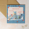 Christmas card with two polar bears and festive text on a striped background
