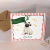 Christmas card with a pug illustration and decorative elements on a striped background