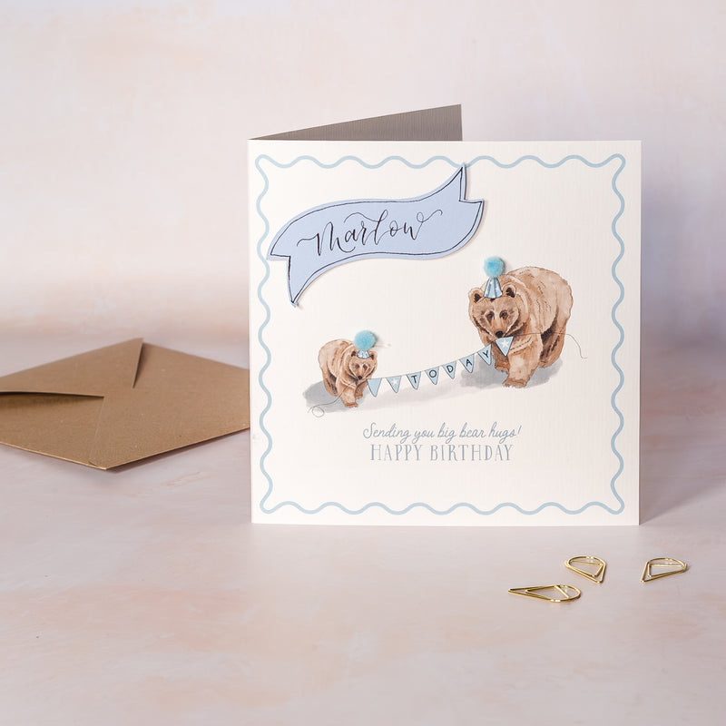 Kids Birthday card with two bears holding a banner and an envelope on a light background