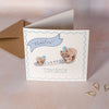 Children's Birthday card with two bears and a blue hat on a light background