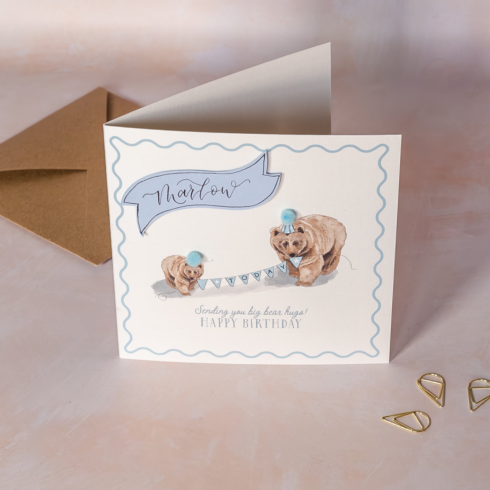 Children's Birthday card with two bears and a blue hat on a light background