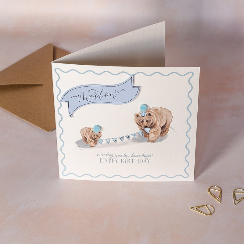 Children's Birthday card with two bears and a blue hat on a light background