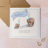 Birthday card with two bears holding a banner and wearing party hats