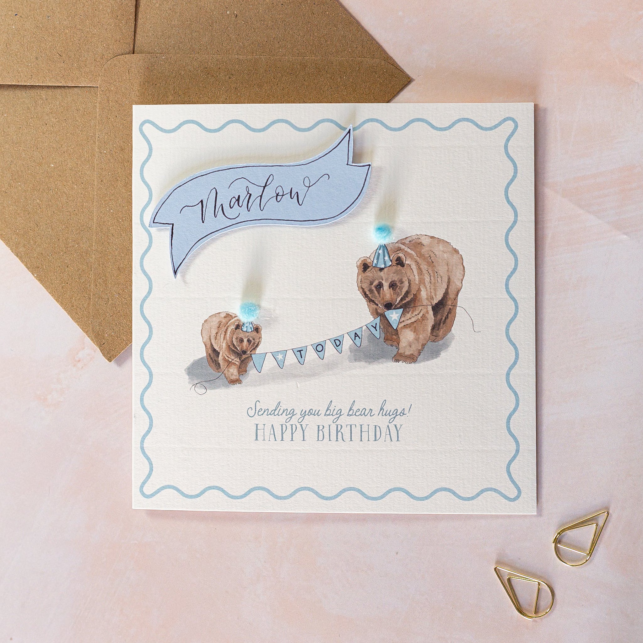 Birthday card with two bears holding a banner and wearing party hats
